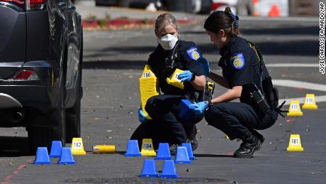 Sacramento Police crime scene investigators work the scene on 10th Street.