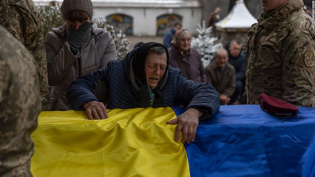 Anna Zhelisko touches the casket of her grandson, Ukrainian soldier Dmitry Zhelisko, as it arrives for his funeral in Chervonohrad, Ukraine, on April 3. He died fighting the Russian army near Kharkiv. 