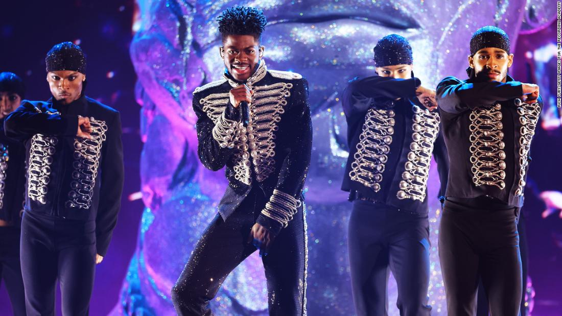 Lil Nas X, flanked by backup dancers, performs a medley of songs during the show.