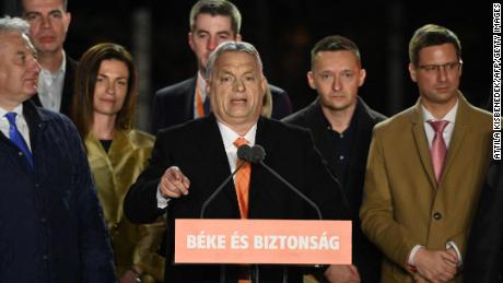 Hungarian Prime Minister Viktor Orban delivers a speech on stage next to members of the Fidesz party at their election base, &#39;Balna&#39; building on the bank of the Danube River of Budapest, on April 3, 2022. - Nationalist Hungarian Prime Minister Viktor Orban claimed a &quot;great victory&quot; in general election, as partial results gave his Fidesz party the lead. (Photo by Attila KISBENEDEK / AFP) (Photo by ATTILA KISBENEDEK/AFP via Getty Images)