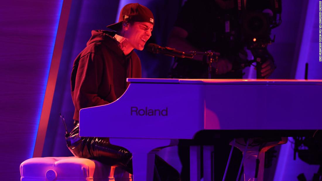 Justin Bieber plays the piano while performing his song &quot;Peaches.&quot;