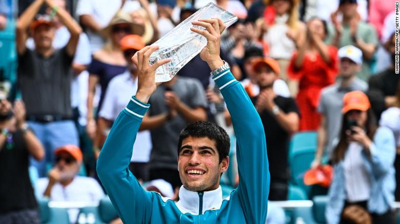 Alcaraz poses with his first Masters 1000 trophy after winning the Miami Open.