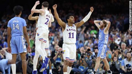Remy Martin #11, Jalen Wilson #10 and Christian Braun #2 of the Kansas Jayhawks react in the second half of the championship game against the North Carolina Tar Heels in New Orleans.