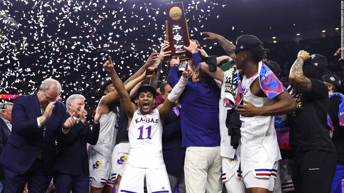 The Jayhawks lift the trophy during the postgame celebrations.