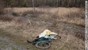 A dead civilian is seen next to his bicycle on a road near the forest in Bucha, Kyiv region. 