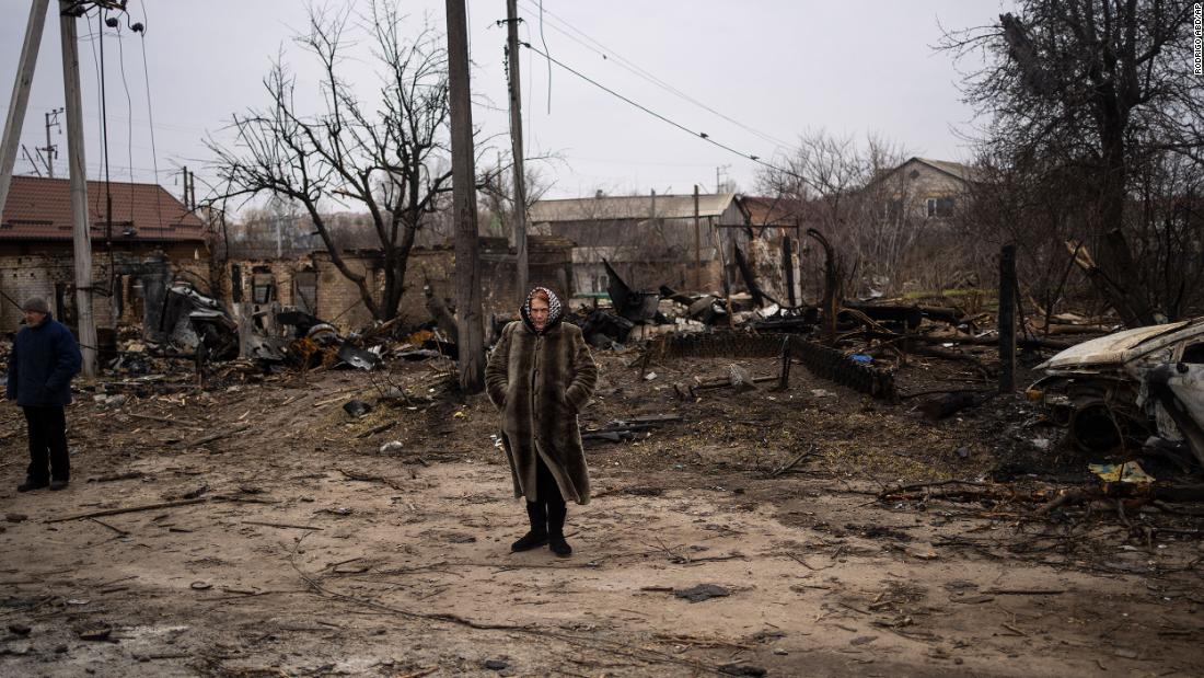 A woman stands in a destroyed area of Bucha on Tuesday.