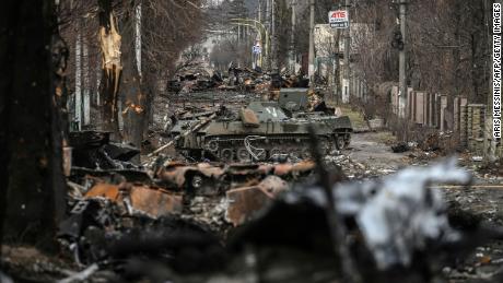 Destroyed Russian armored vehicles are seen on the streets of Bucha on Monday.
