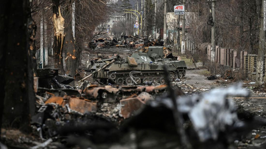 Destroyed Russian armored vehicles are seen on the streets of Bucha on Monday.