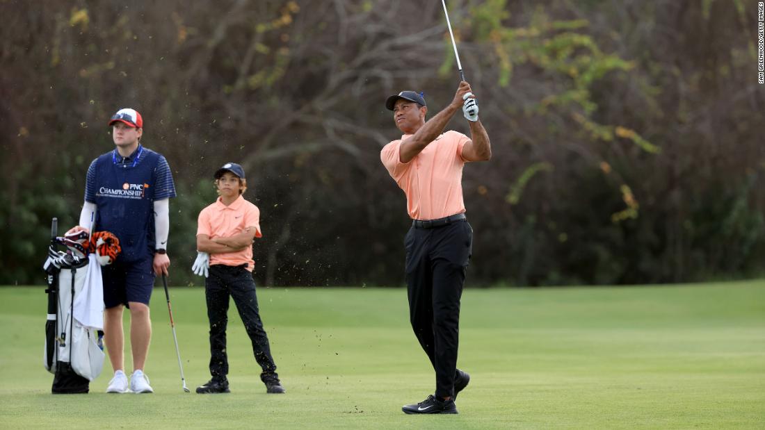 Woods plays a shot at the PNC Championship as his son, Charlie, watches in December 2021. It was Tiger&#39;s first time competing since the car crash, and he used a golf cart to get around the course. He and Charlie &lt;a href=&quot;https://www.cnn.com/2021/12/18/sport/tiger-woods-pnc-championship/index.html&quot; target=&quot;_blank&quot;&gt;finished in second place.&lt;/a&gt; &quot;I&#39;m a long way away from playing tournament golf,&quot; Tiger said. &quot;This is hit, hop in a cart.&quot;