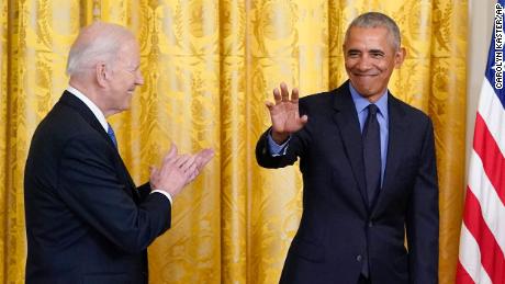 President Joe Biden applauds as former President Barack Obama arrives on stage during an event about the Affordable Care Act, in the East Room of the White House in Washington, Tuesday, April 5, 2022. (AP Photo/Carolyn Kaster)
