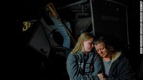 Amber Zeleny, 53, right, is comforted by her daughter Brittaney Deaton, 17, on Tuesday after a severe storm in Johnson County, Texas.