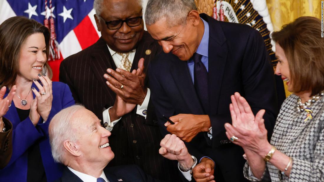 Biden fist-bumps Obama after Biden signed an executive order aimed at strengthening the Affordable Care Act.