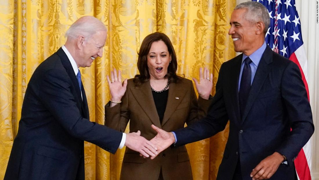 Harris reacts as Biden and Obama shake hands in the East Room.