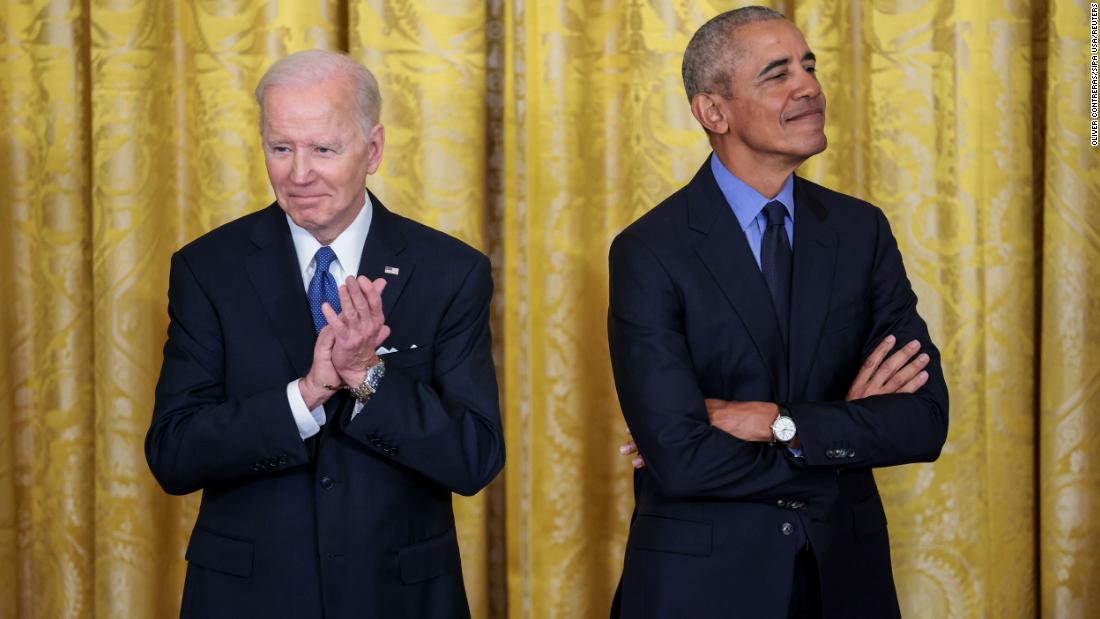 Biden and Obama listen to Harris speak Monday.
