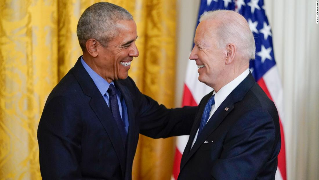 Former President Barack Obama shakes hands with President Joe Biden in the East Room of the White House on Tuesday, April 5