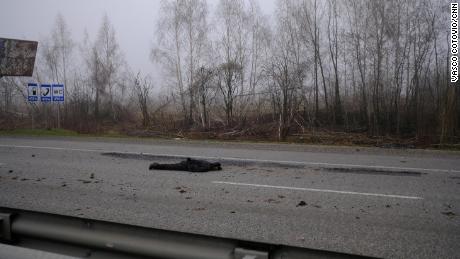 A decomposing body lies in the middle of the E-40 highway, which connects Lviv to Kyiv, a day after it was retook by Ukrainian forces.