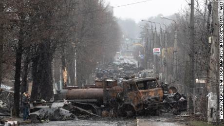 Burnt trucks and Russian military equipment are seen in the streets of Bucha on April 3 after the withdrawal of Russian troops from the city.