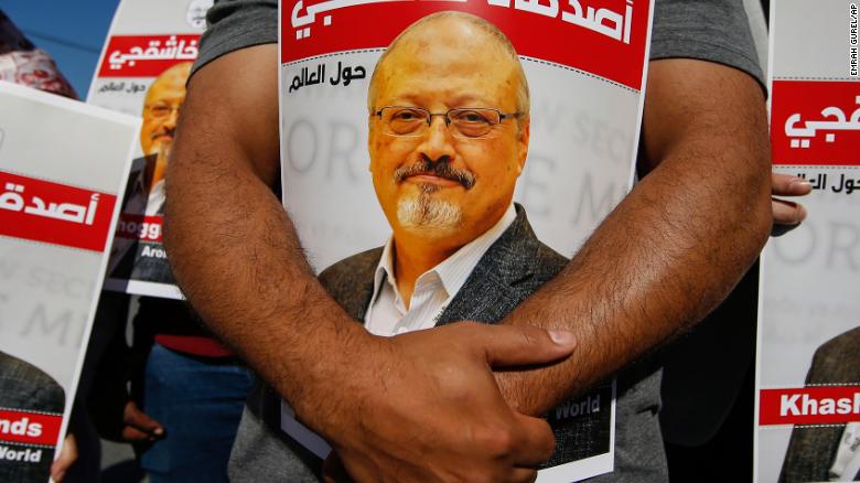 People hold posters of slain Saudi journalist Jamal Khashoggi near the Saudi Arabian consulate in Istanbul, marking the two-year anniversary of his death on Friday, October 2, 2020.
