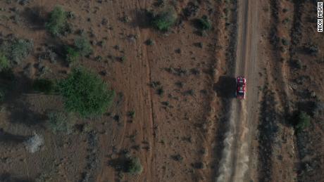 A classic rally car races across the Kenyan landscape