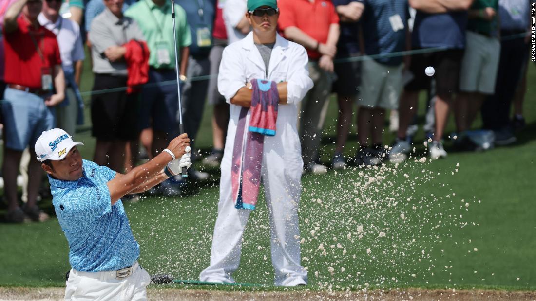 Defending champion Hideki Matsuyama plays a shot from a bunker on the second hole Thursday. &lt;a href=&quot;https://www.cnn.com/2021/04/08/golf/gallery/masters-golf-2021/index.html&quot; target=&quot;_blank&quot;&gt;When he won the green jacket last year,&lt;/a&gt; Matsuyama became the first Japanese man to win any of the four major championships.