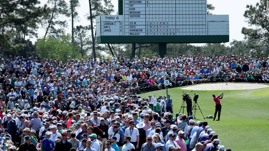 A crowd watches Woods tee off on the third hole Thursday.