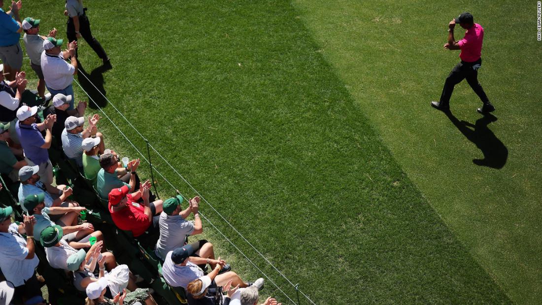 Woods is applauded as he walks onto the 16th tee on Thursday.