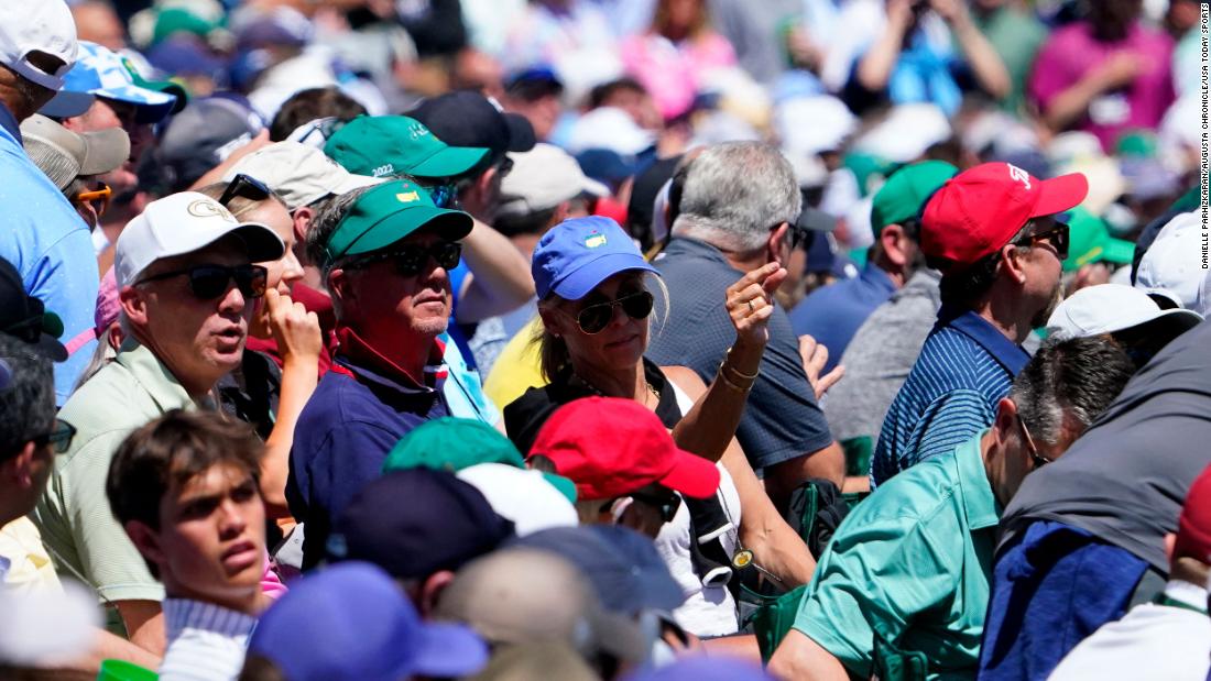 People watch Woods tee off on the 12th hole Thursday.