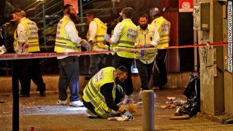 Forensics experts investigate the scene of a shooting in Tel Aviv, Israel, on Thursday.