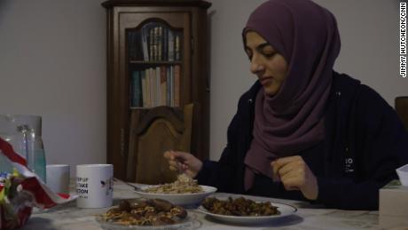 Hiba Latreche eats breakfast before fasting during Ramadan.