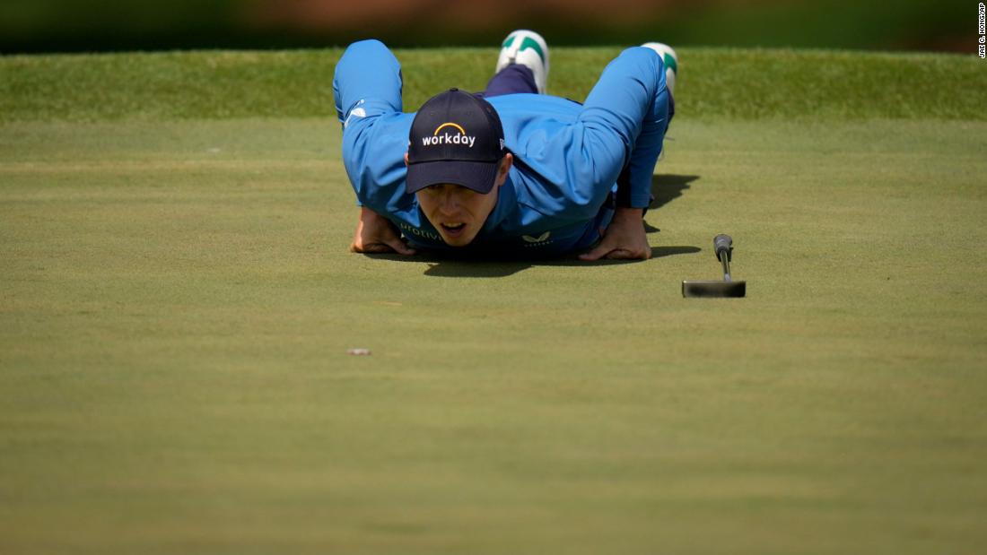 Matthew Fitzpatrick lies on the seventh green to visualize a putt on Friday.