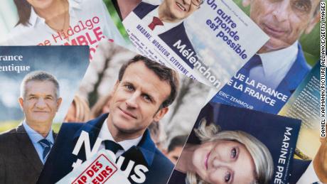 Election posters of French presidential candidates are shown.