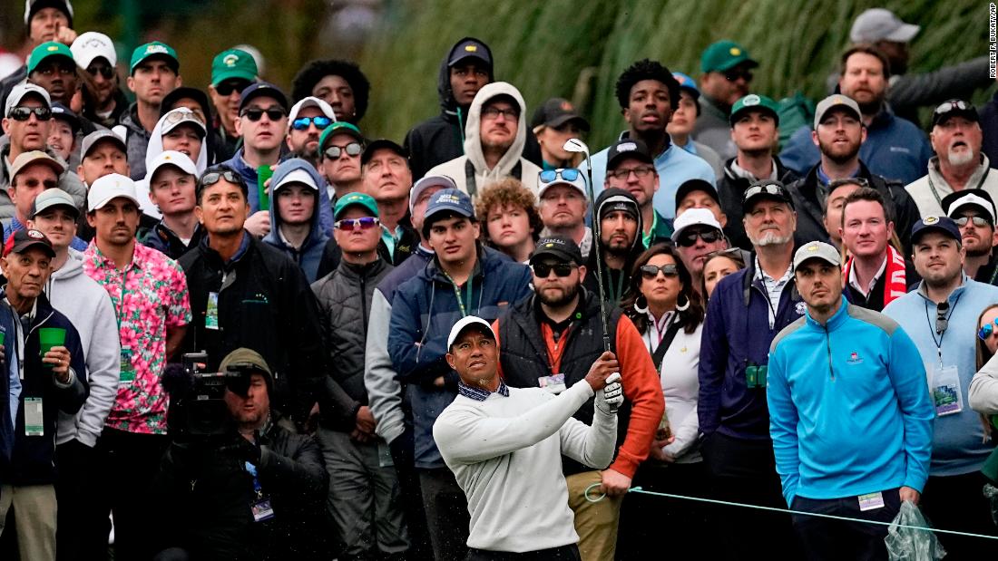 A crowd watches Woods hit a shot on the third hole Saturday.