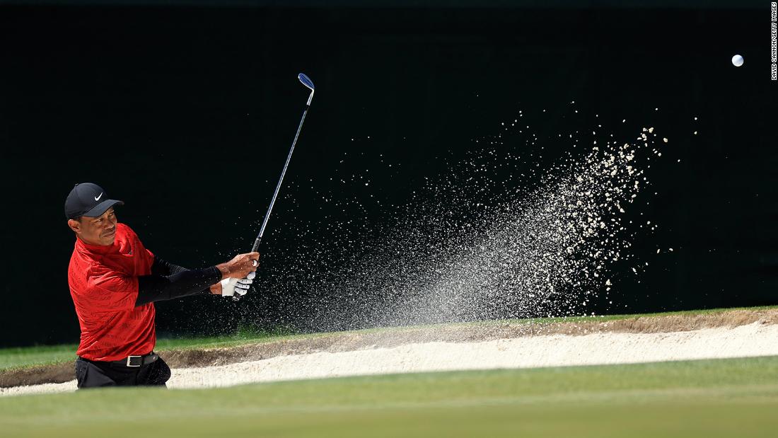 Tiger Woods plays a shot from the bunker on the third hole Sunday. He shot a 78 for the second straight day, his worst score ever at the Masters. 