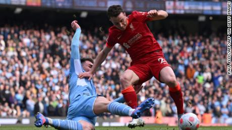 Manchester City&#39;s French defender Aymeric Laporte tackles Liverpool&#39;s Portuguese striker Diogo Jota during the Premier League match between Manchester City and Liverpool.