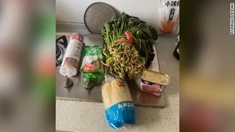 A government food package sent to Shanghai residents Rodrigo Zeidan and Melissa Nogueira, including noodles, sausages, spinach, mushrooms, SPAM. 