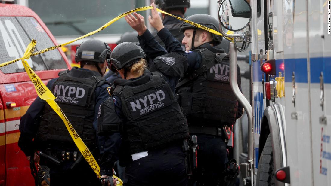 Police officers work near the scene of the shooting.