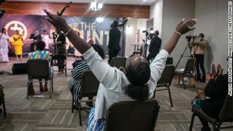 A church member raises his hands in worship during an Easter Sunday service at New Mount Calvary Missionary Baptist Church on Sunday, April 4, 2021, in Los Angeles.