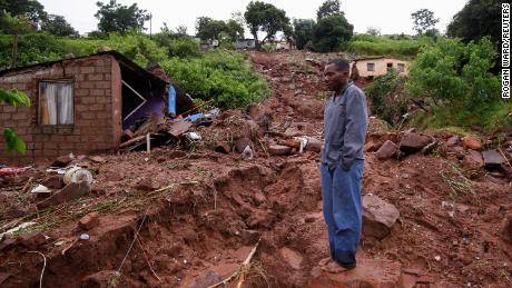 Jomba Phiri walks over where his house stood after heavy rains caused flood damage in KwaNdengezi, Durban, South Africa, April 12, 2022. REUTERS/Rogan Ward