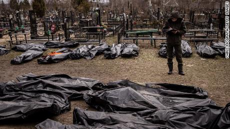 A man works to catalog some of the bodies discovered in Bucha, after Russian forces withdrew from the area.