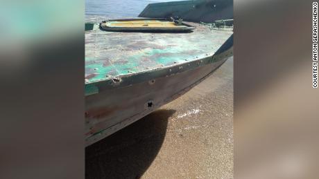 Bullet or shrapnel holes are depicted on the boat that was attacked.