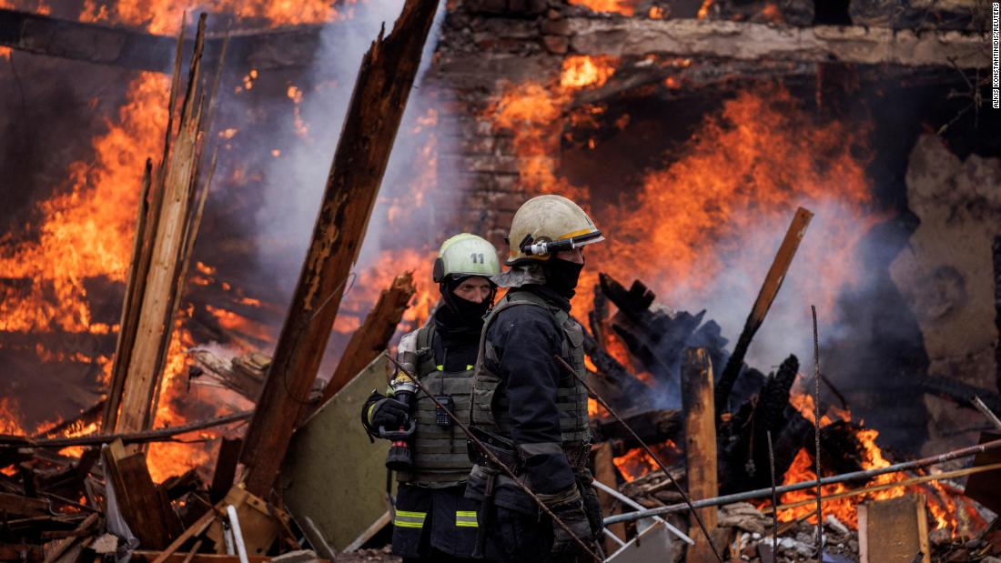 Firefighters work at a burning building in Kharkiv following a missile attack near the Kharkiv International Airport on April 12.