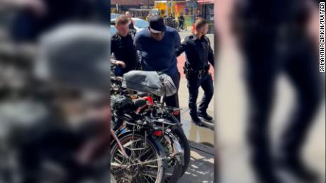 CNN obtained video showing the arrest of subway shooting suspect Frank James who was taken into custody in New York City Wednesday. The video shows James in handcuffs being escorted by two police officers in the street.
