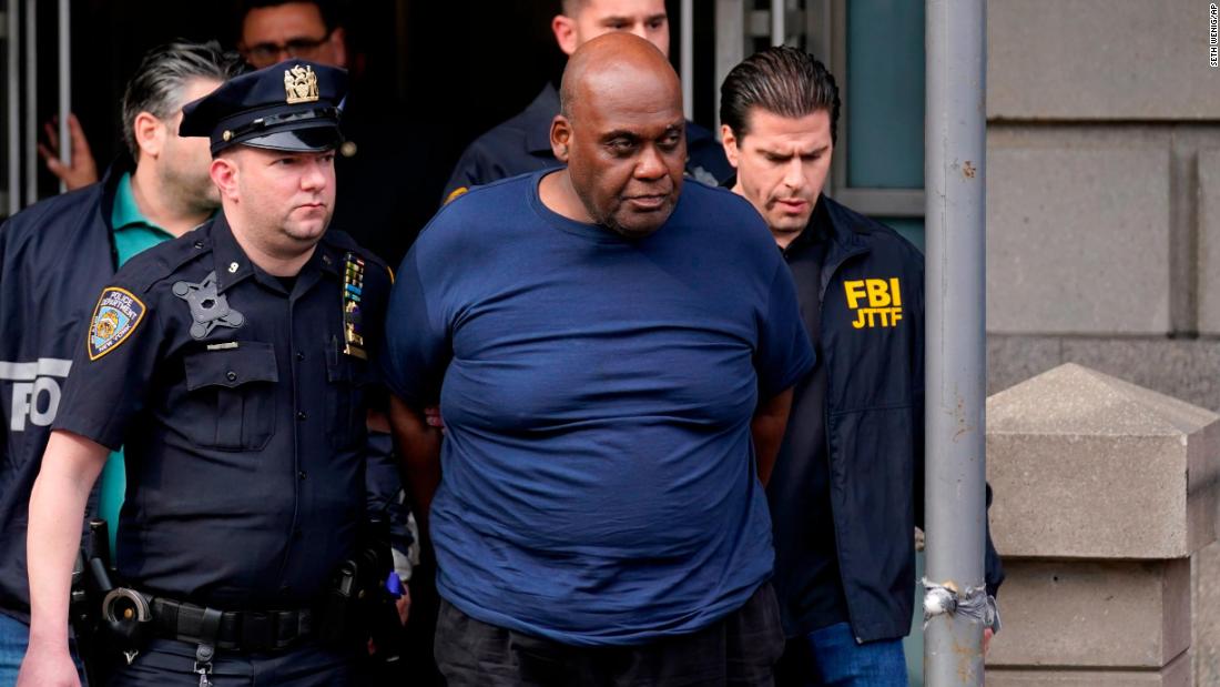 Law enforcement officials lead subway shooting suspect Frank James away from a police station in New York on Wednesday, April 13. James was arrested Wednesday and charged with a federal offense.