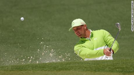 DeChambeau plays his shot from the bunker on the second hole during the second round of The Masters.