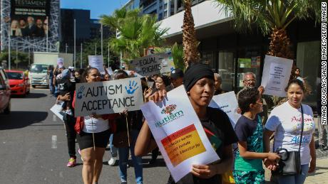 A group marches this month in Cape Town, South Africa, to demand services and support for families with children who are autistic.