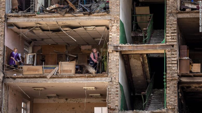 Women clean inside a damaged building at the Vizar company military-industrial complex in Vyshneve, Ukraine, on Friday, April 15. The site on the outskirts of Kyiv was hit by Russian strikes.
