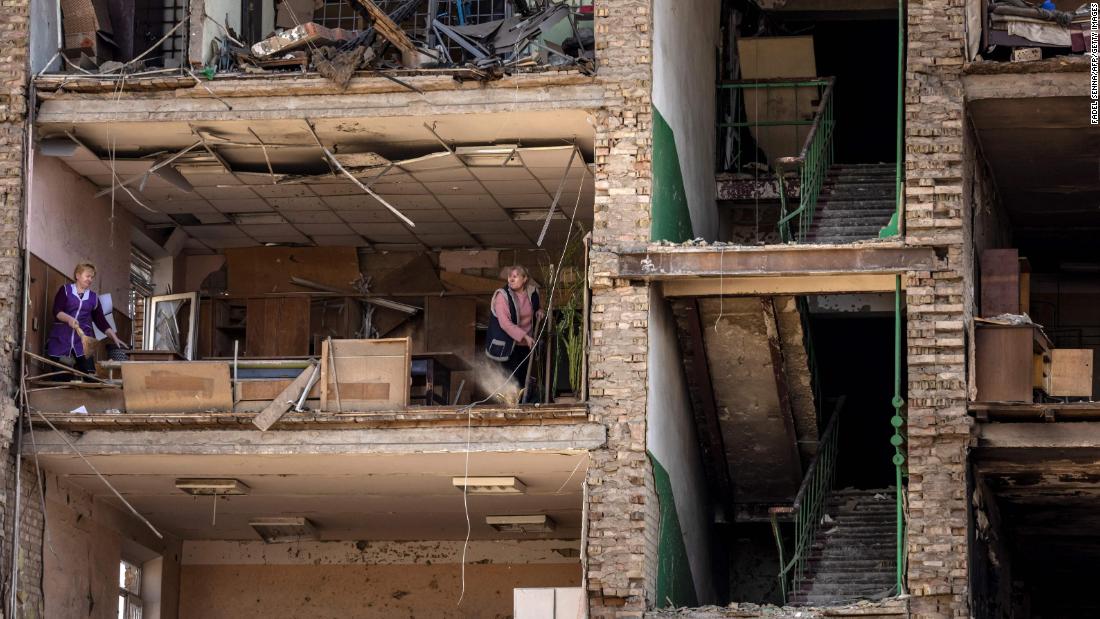 Women clean inside a damaged building at the Vizar company military-industrial complex in Vyshneve, Ukraine, on April 15. The site, on the outskirts of Kyiv, was hit by Russian strikes.