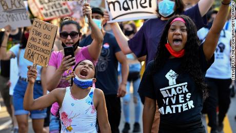 Cristiana Gant, 9, left, shouts alongside fellow activists during a protest in Garden City, New York, against police brutality in the wake of the death of George Floyd, on June 23, 2020. 