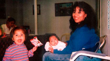 Melissa Lucio holds her daughter Mariah, while daughter Adriana stands next to them.