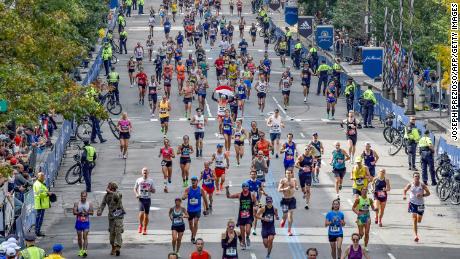 Runners make their way to the finish line down Boylston Street during the 125th Boston Marathon on October 11, 2021. 